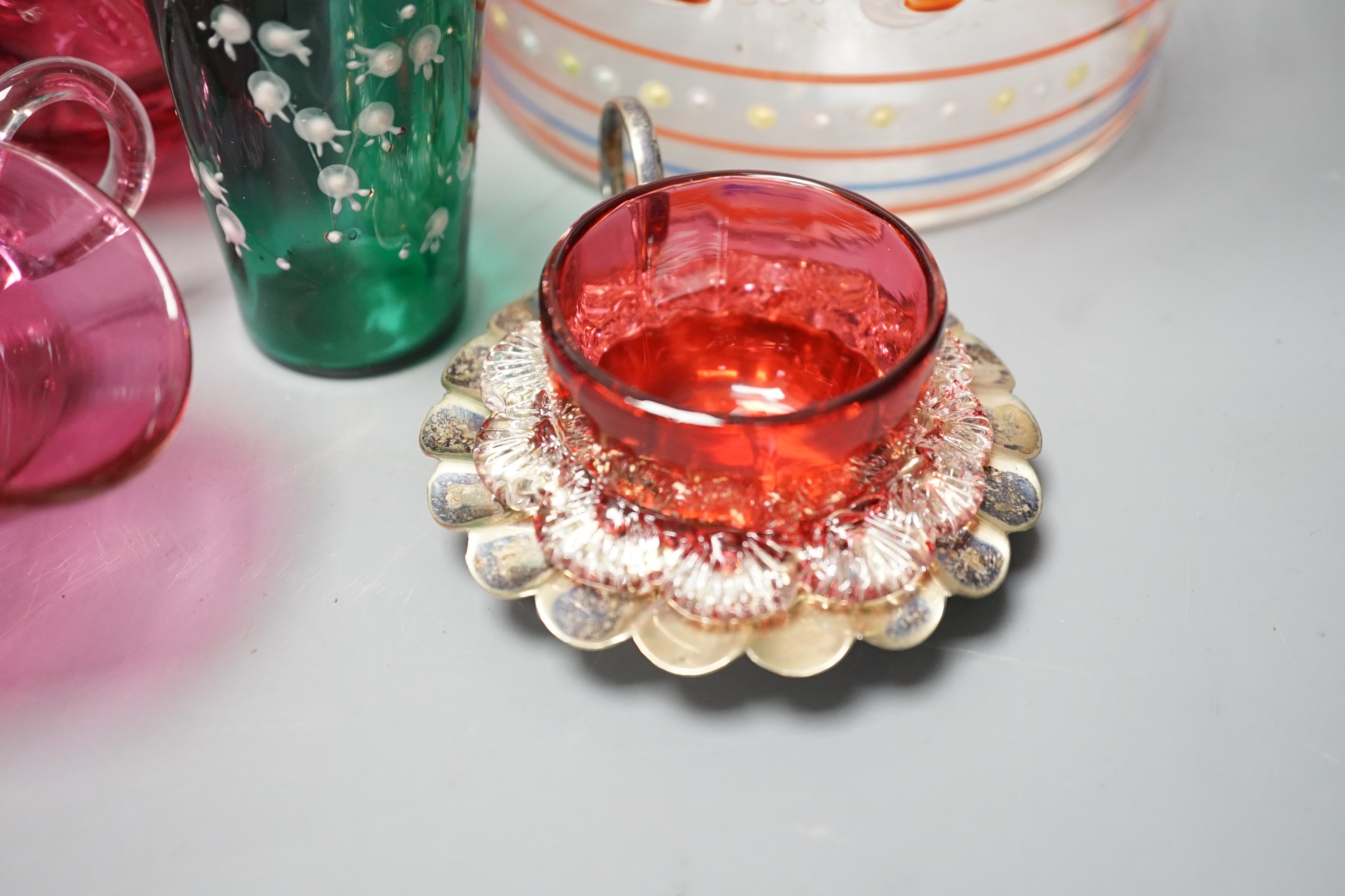 A collection of cranberry glass, a silver lidded glass sugar bowl, and enamelled glass historismus humpen etc